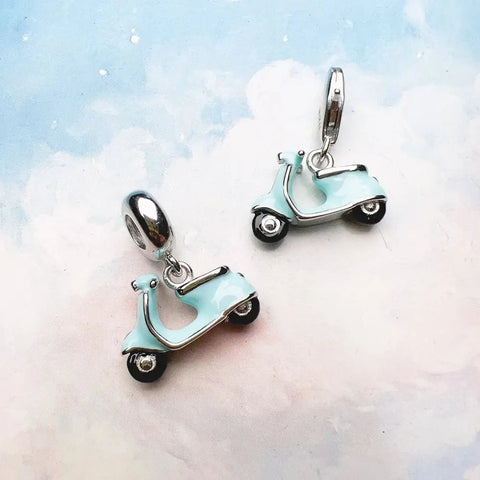 Two light blue scooter charms.