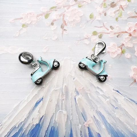 Two light blue scooter charms.