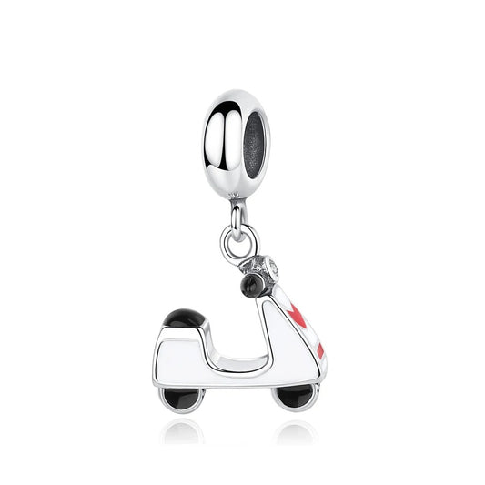 Silver tone dangle charm shaped like a retro motor scooter with white and red enamel bodywork, black enamel wheels, and crystal handlebar accents, shown hanging from a bracelet bead fitting