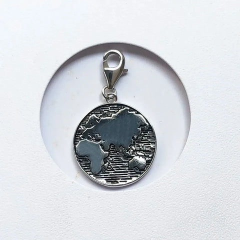 Silver world map charm.