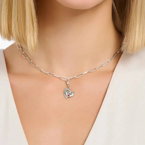 Silver chain necklace with heart pendant.