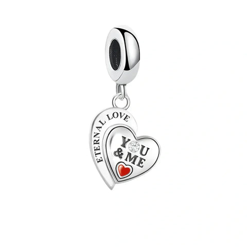 Silver heart charm with 'You & Me' inscription.
