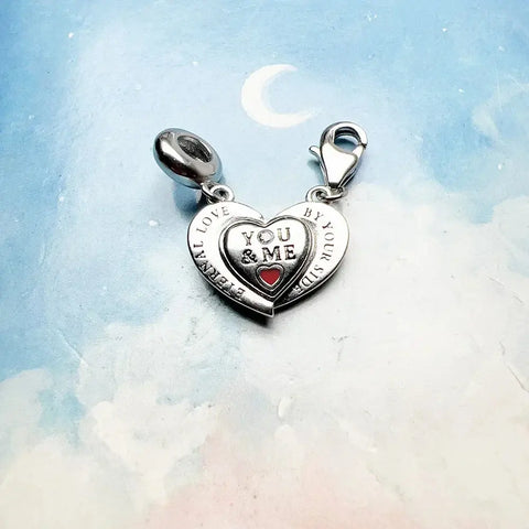Silver heart charm with 'You & Me' inscription.