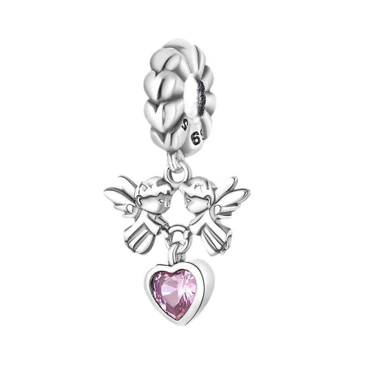 Sterling silver charm featuring two angels holding a pink heart-shaped gemstone.