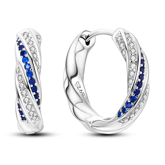 Sterling silver twisted hoop earrings with blue diamonds.