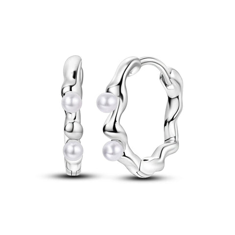Sterling silver hoop earrings with baroque pearls.