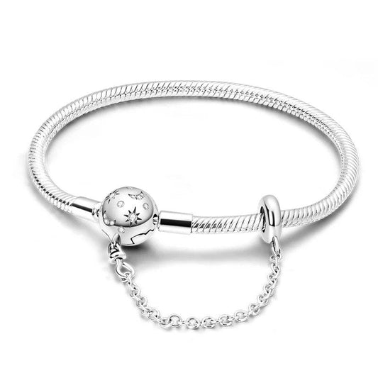 Celestial dreams charm sterling silver snake chain bracelet with moon and star engravings.