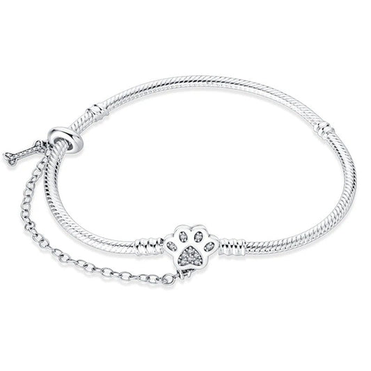 Paw prints charm sterling silver snake chain bracelet with crystal-studded paw clasp and bone tag