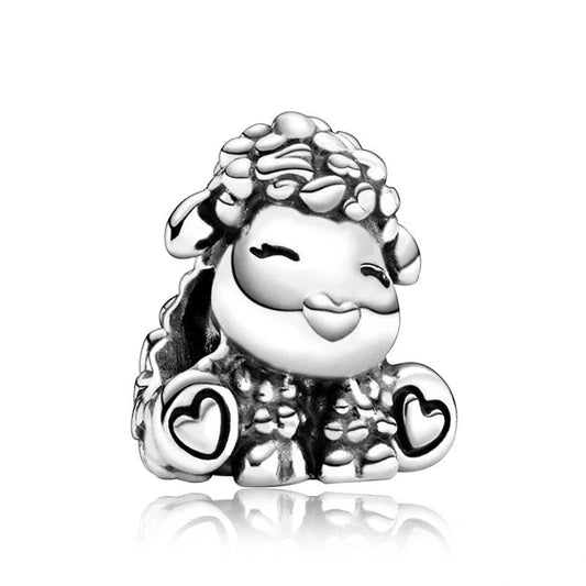 Sterling silver charm of a cheerful sheep with heart details on its feet, fitting Pandora bracelets