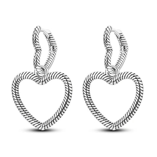 Sterling silver heart-shaped hoop earrings with detailed design.