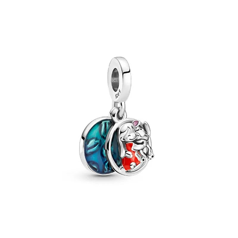 Sterling silver charm of Lady and Tramp shaband a spaghetti kiss with colorful enamel accents.