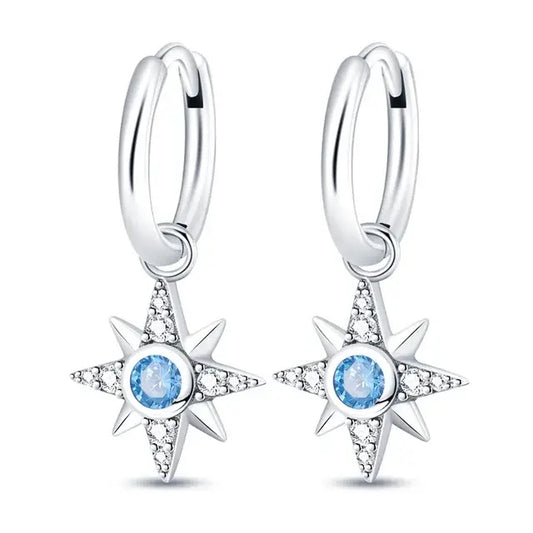 Sterling silver North Star drop earrings with blue cubic zirconia stones.