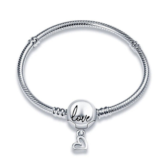 Sterling silver bracelet with a round charm engraved with "Love" and a dangling heart.